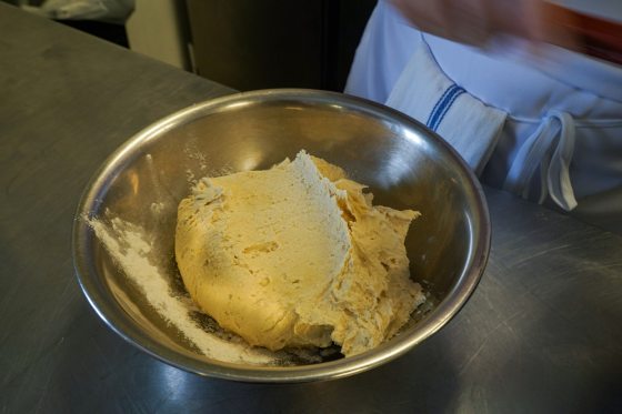 dough resting in a metal bowl